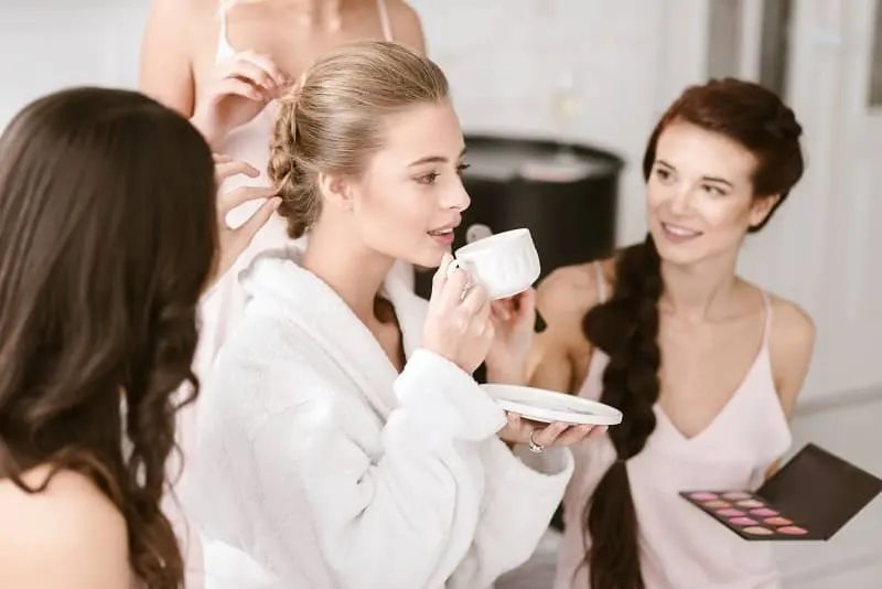Pleasant young bride drinking tea and getting ready-cm